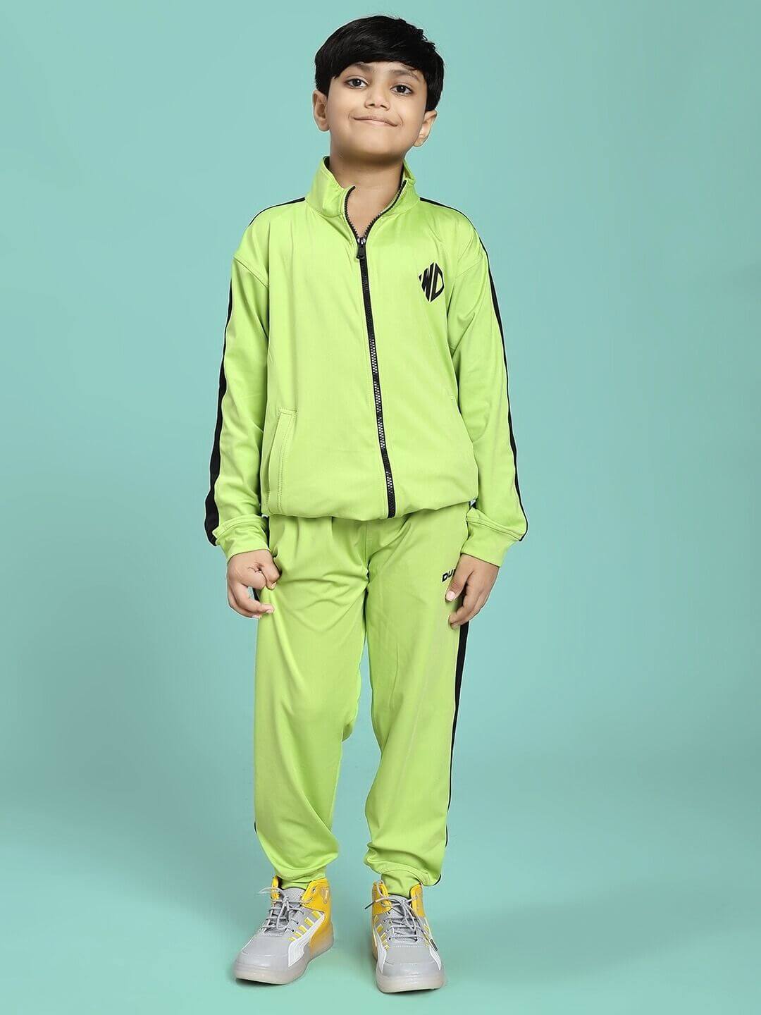 Boy wearing HIGH PERFORMANCE JOGGER FOR BOYS AND GIRLS NEON GREEN sportswear, standing on a teal background.