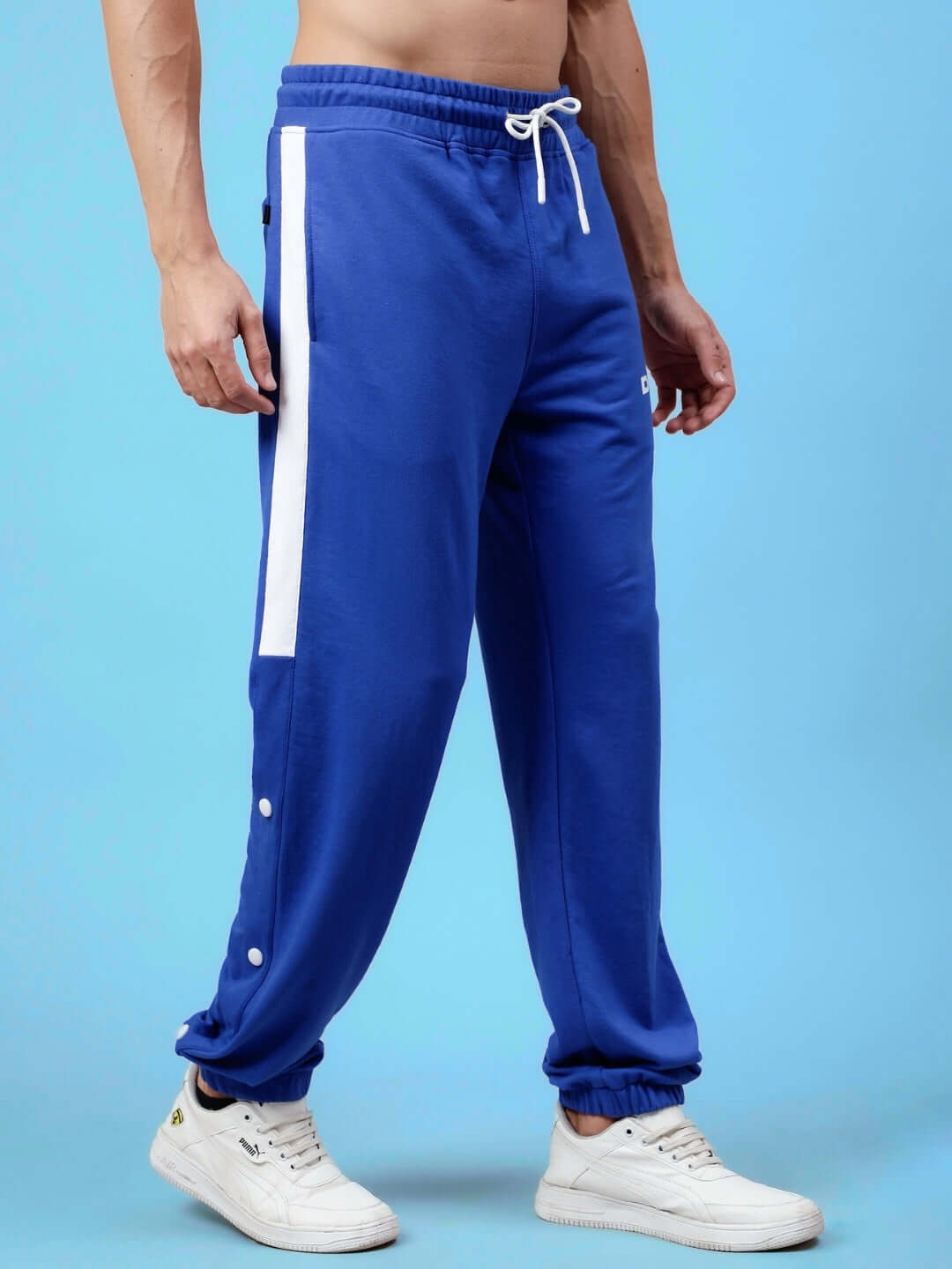 Man wearing high point contrast joggers in royal blue and white, featuring custom fit option and made to order by DUDS.