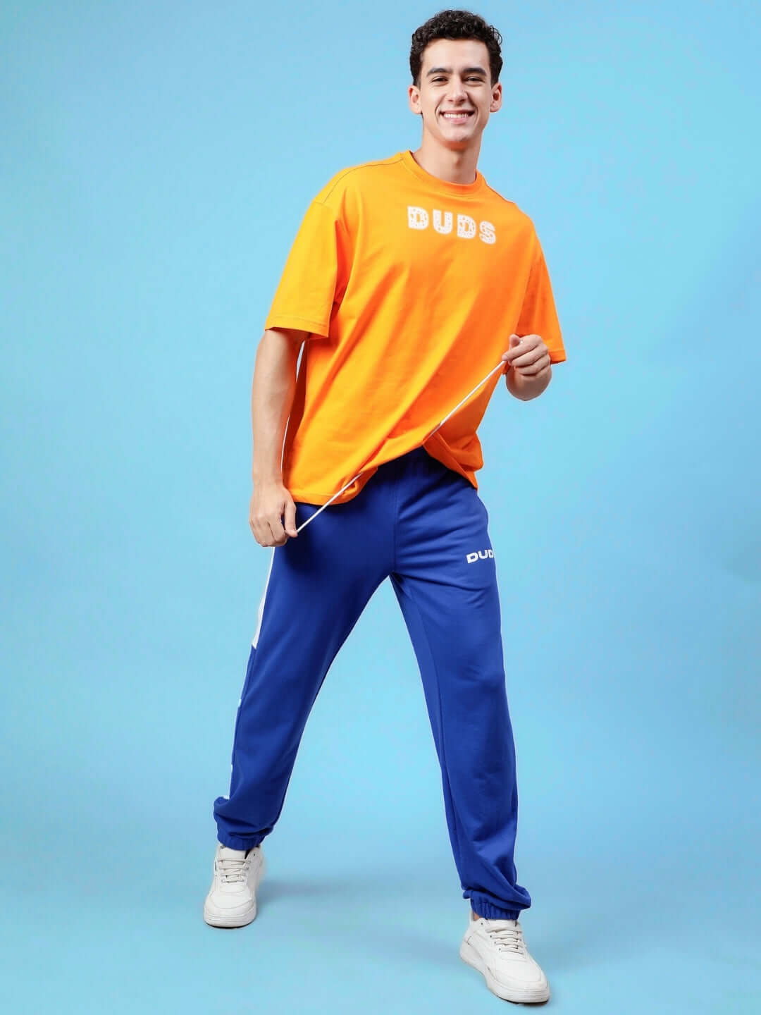 Person wearing High Point Contrast Joggers in royal blue and white with an orange DUDS top, showcasing casual style.