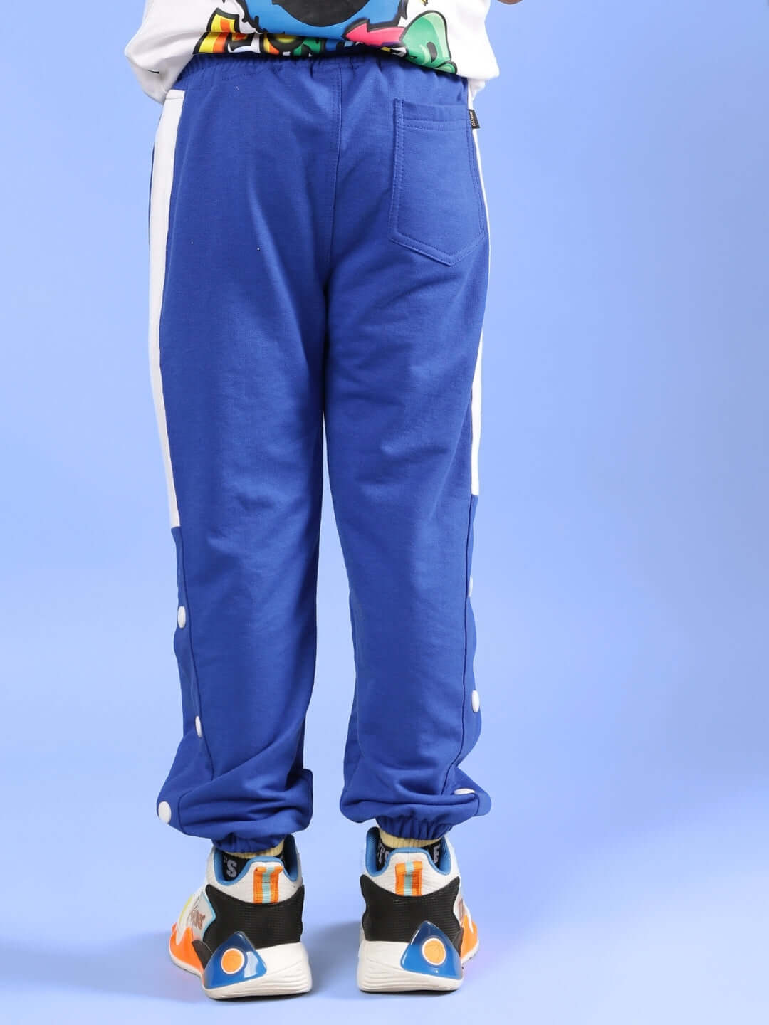 Child wearing HIGH POINT JOGGER FOR BOYS & GIRLS ROYAL BLUE pants, showcasing sporty style and comfort ideal for active kids.