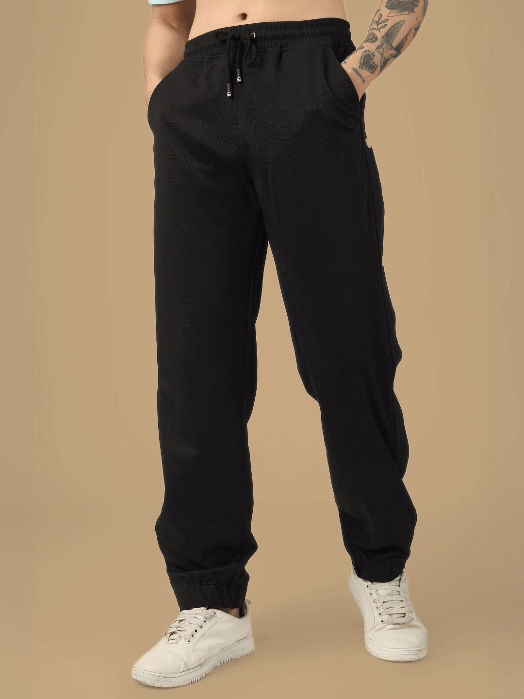 Model wearing black hip hop joggers from DUDS, showcasing comfortable fit and casual style.