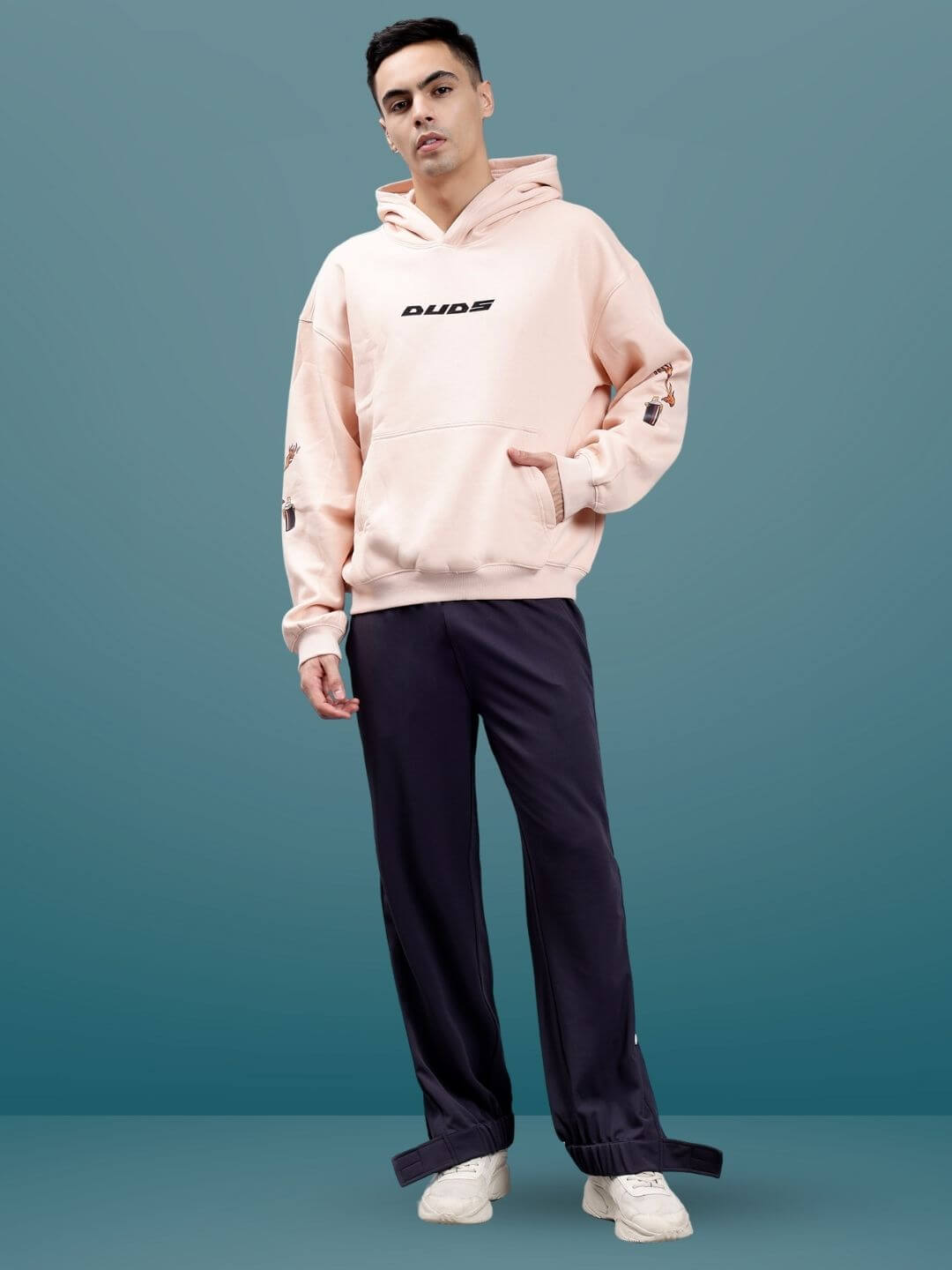Model wearing HIP HOP JOGGERS in dark steel grey paired with a light pink DUDS hoodie, showcasing a trendy and casual style.