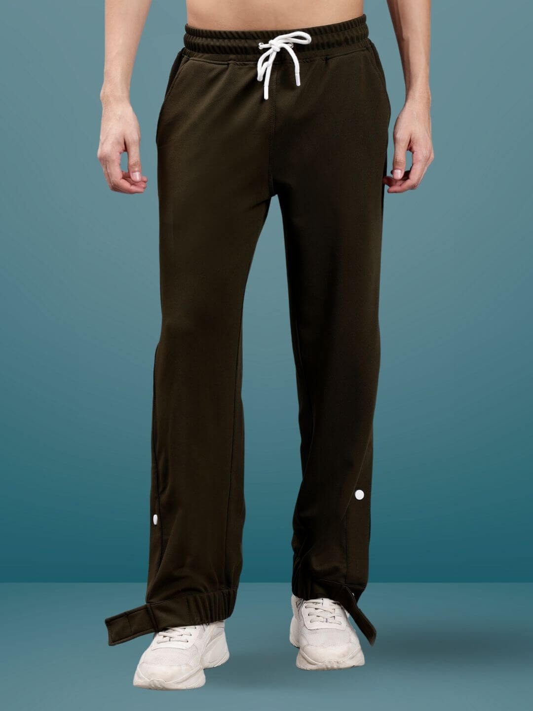 Model wearing HIP HOP JOGGERS in military green, showing customizable fit with white drawstring and button details, made to order by DUDS.