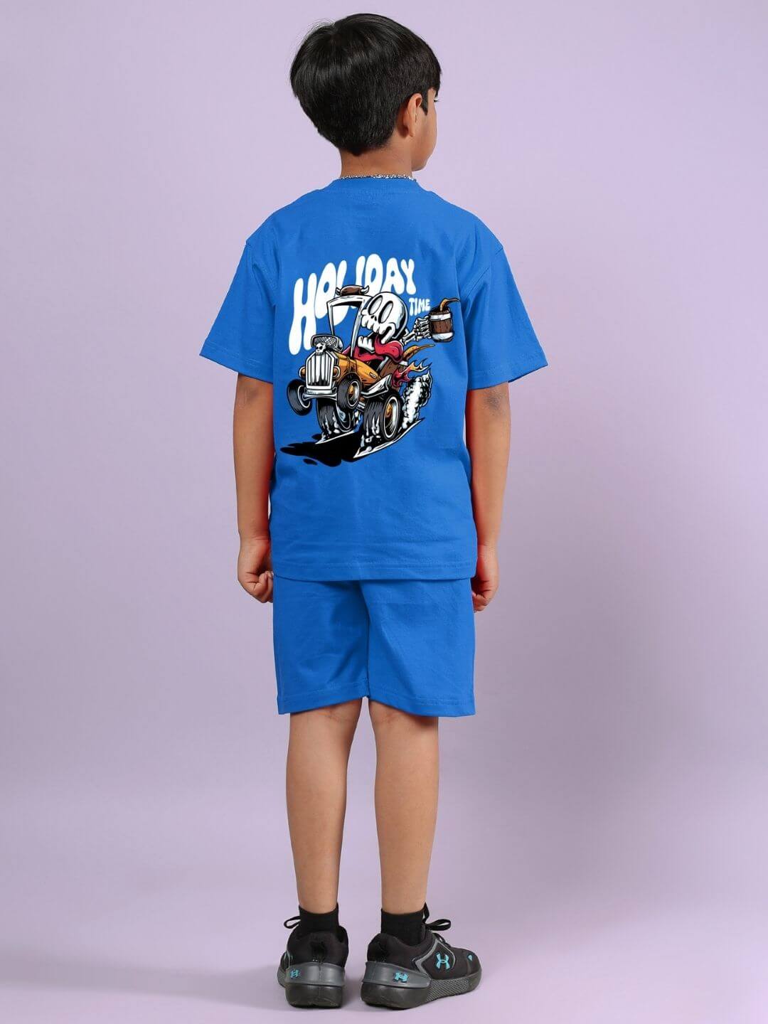 Boy wearing Holiday Time Rider Print Co-ord for Boys and Girls Blue, showcasing back design with fun rider print, standing on purple background.