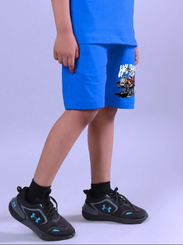 Child wearing Holiday Time Rider Print Shorts in Blue with a casual t-shirt and sneakers, showcasing the trendy design for active play.