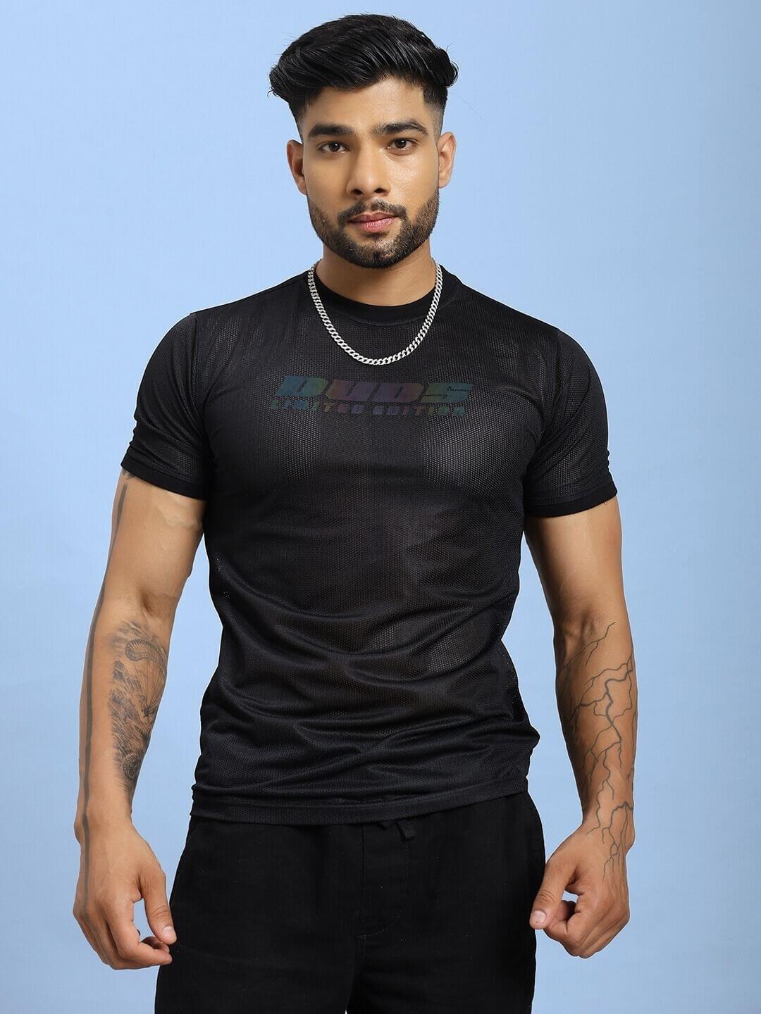 Model wearing HOLO BLACK MESH REGULAR FIT T-SHIRT BLACK showcasing mesh panels and relaxed fit on blue background