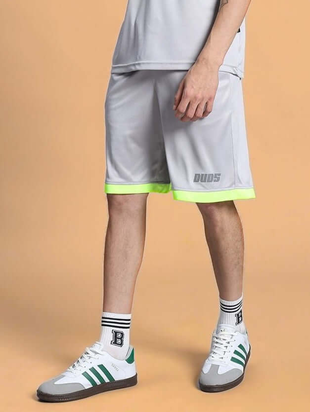 Man wearing HOOKUP REGULAR FIT SHORTS GREY with sneakers, showcasing casual style.