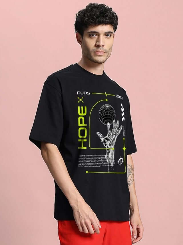 Model wearing HOPE PRINTED OVERSIZED T-SHIRT BLACK with bold "HOPE" print and graphic design.
