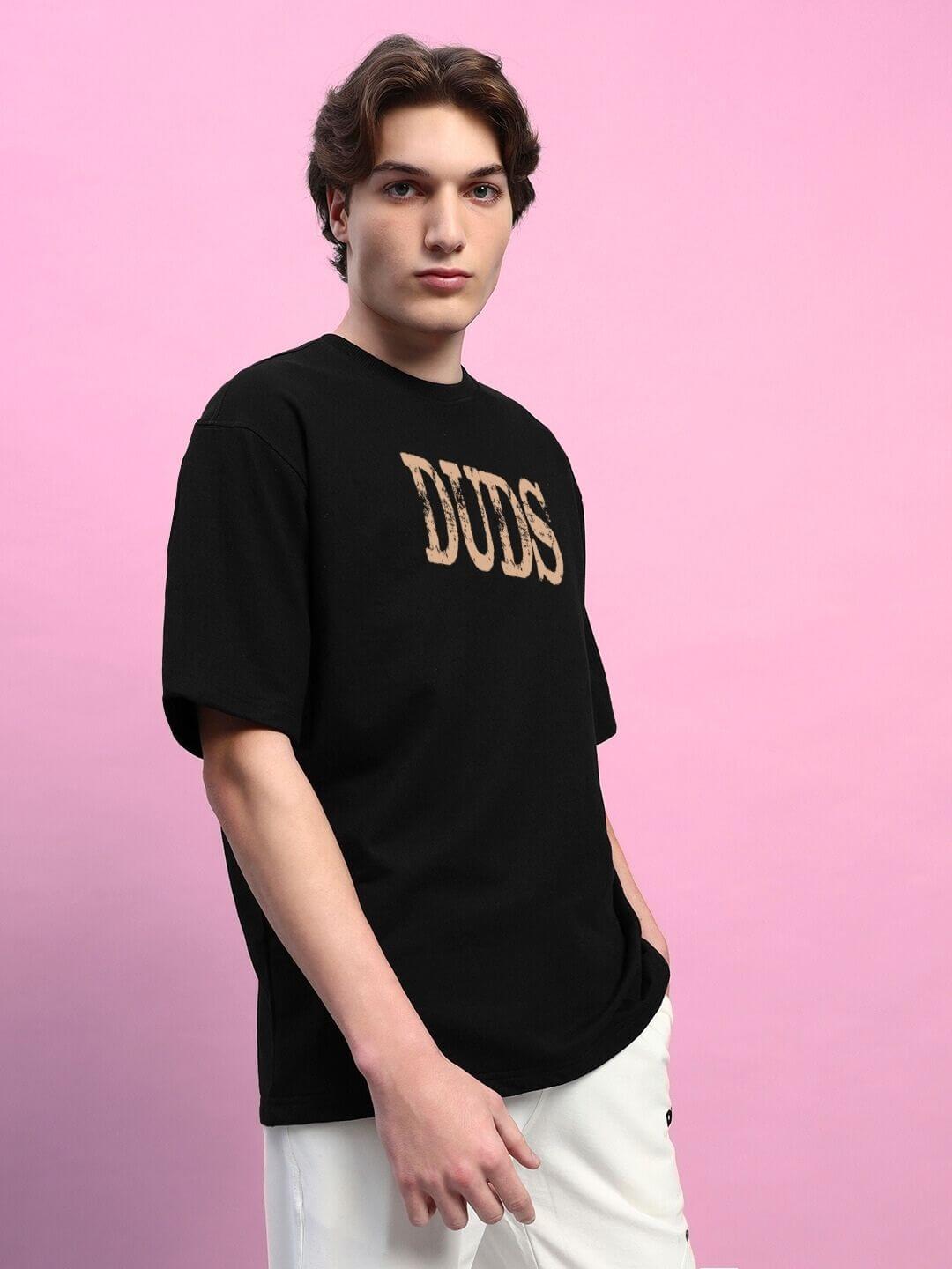 Man wearing HORNED FIGURE CREATIVE PRINT OVERSIZED T-SHIRT BLACK with casual style on a pink background.
