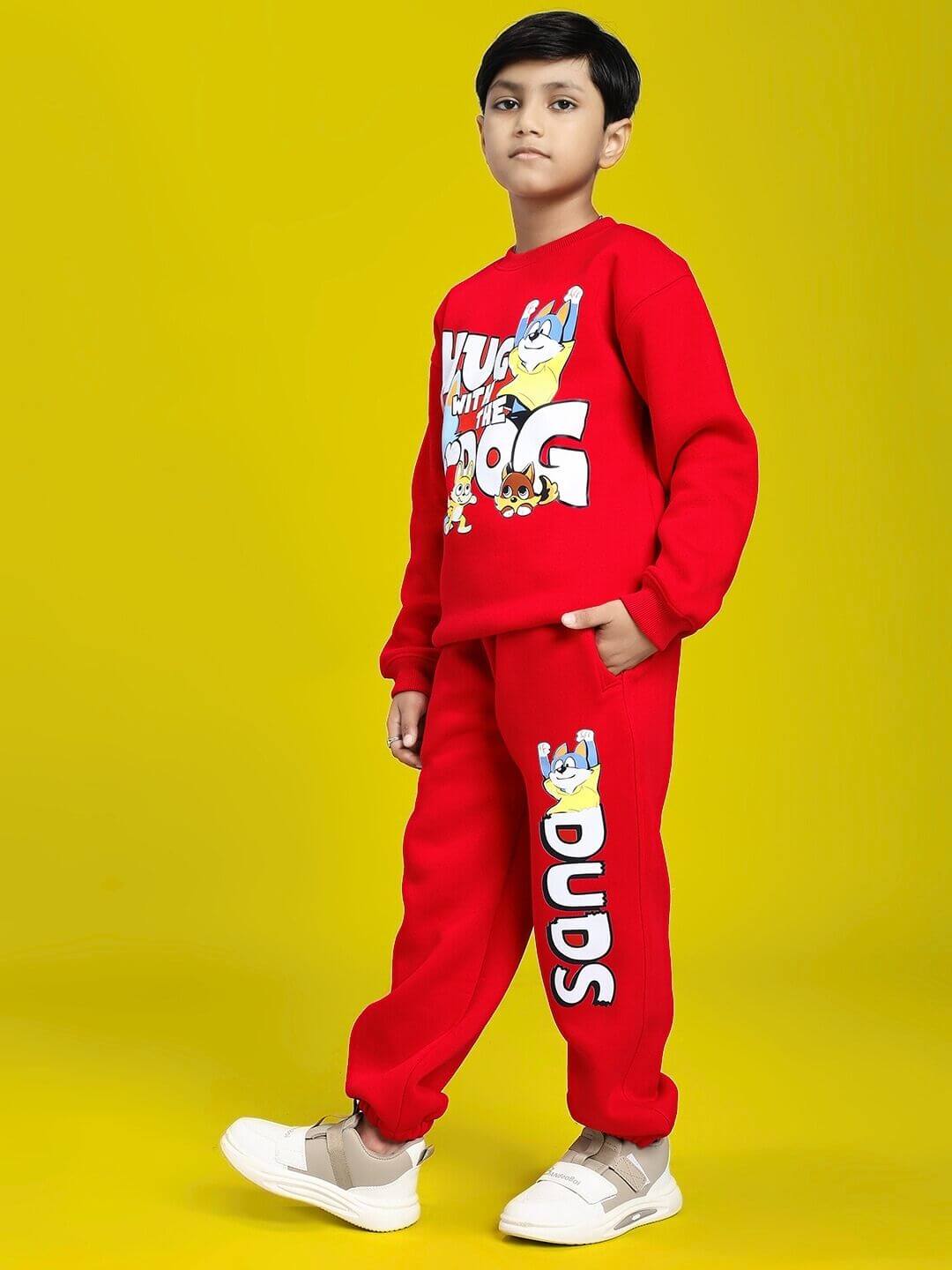 HUG WITH THE DOG FLEECE CO-ORD FOR BOYS AND GIRLS RED, kid in red outfit with dog graphic, cozy and playful clothing for kids.