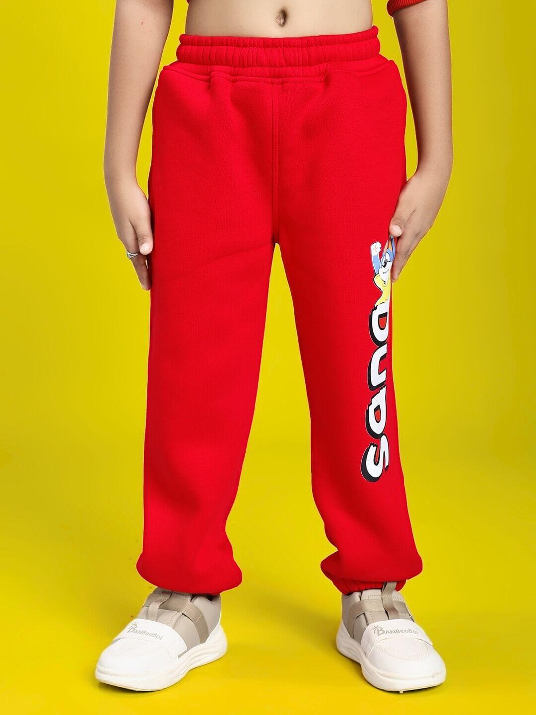 Child wearing HUG WITH THE DOG FLEECE JOGGER FOR BOYS AND GIRLS RED with playful design.