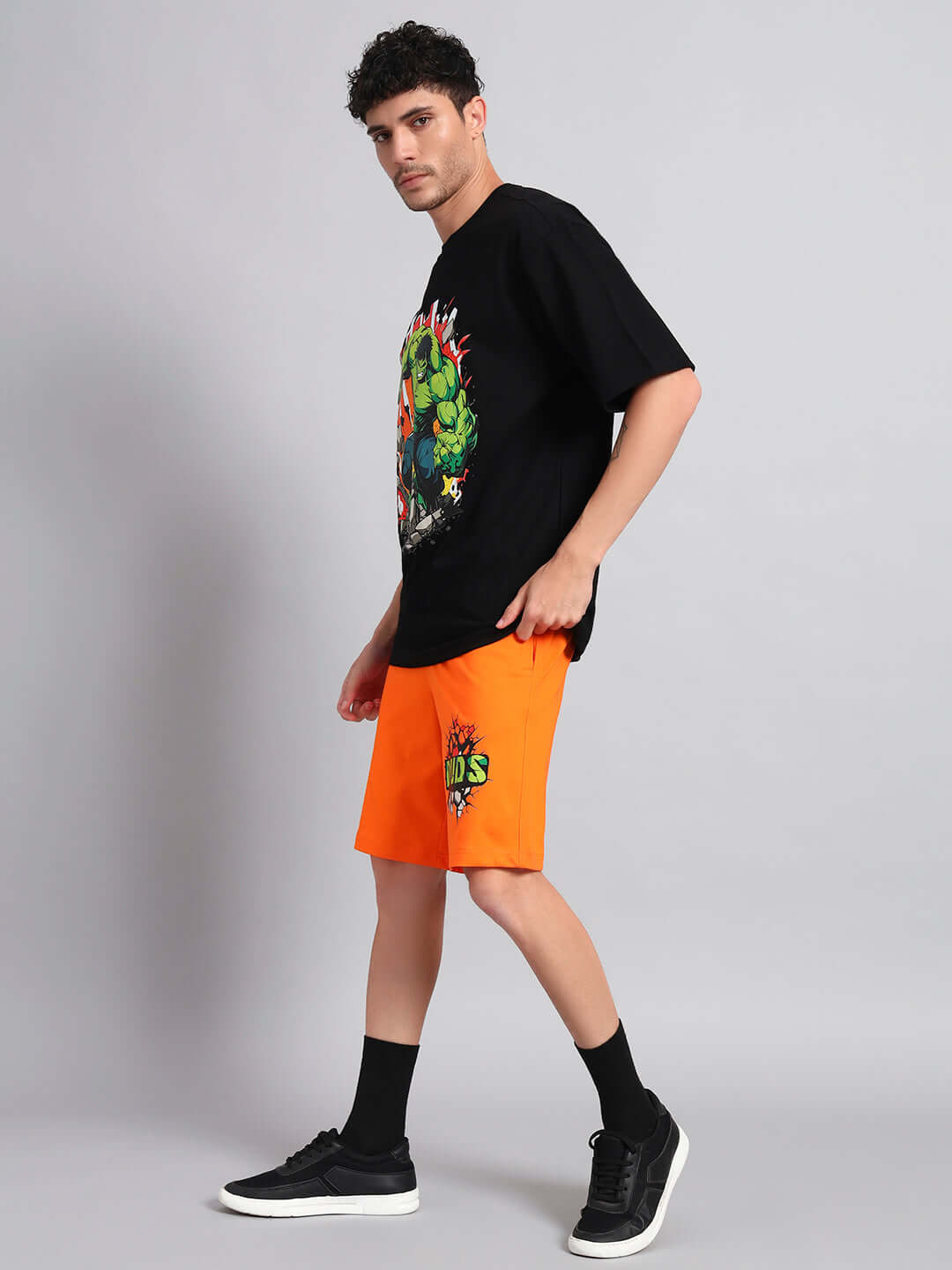 Model wearing HULK CO-ORD Set in black and orange, featuring premium cotton French terry fabric. Ideal for casual wear. Made in India.