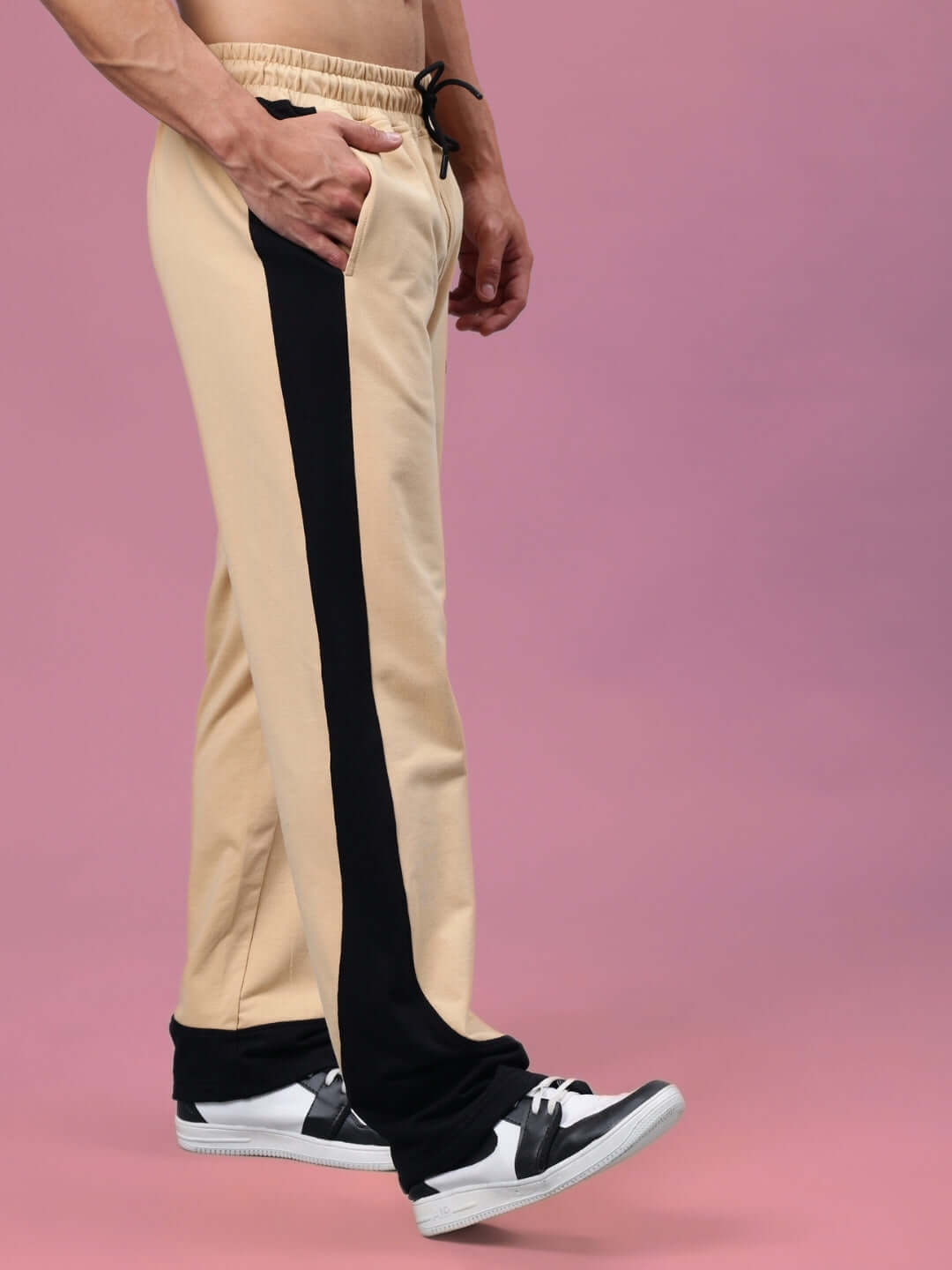 Stylish beige-black joggers with custom fit option, made by DUDS. Perfect for casual wear with a unique two-tone design.