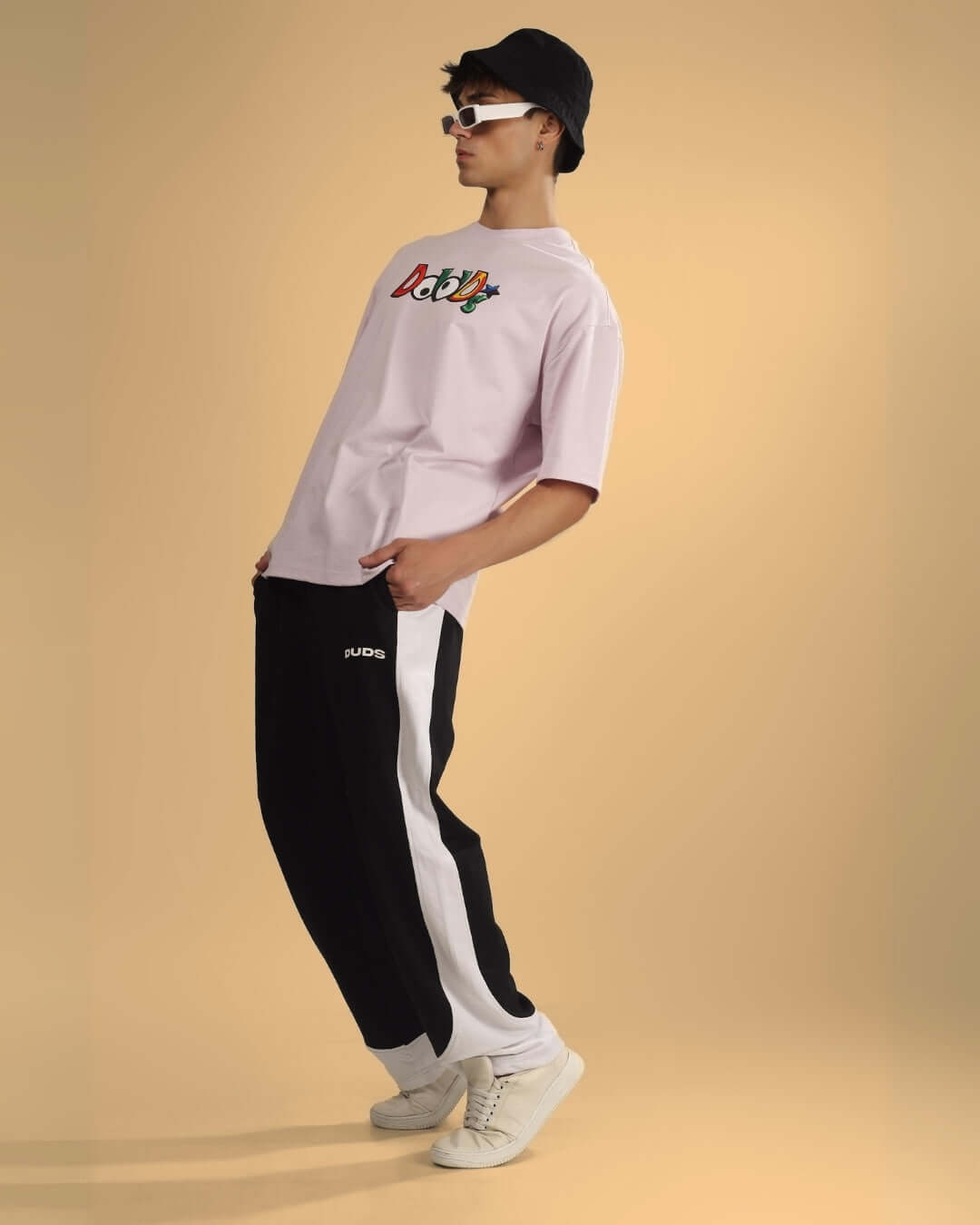 Fashion model wearing HURTLE BAGGY JOGGERS in black and white, styled with DUDS t-shirt, showcasing modern streetwear look.