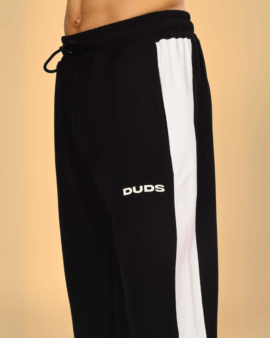 Close-up of DUDS Hurtle Baggy Joggers in Black-White, featuring a sporty design with customizable fit options.
