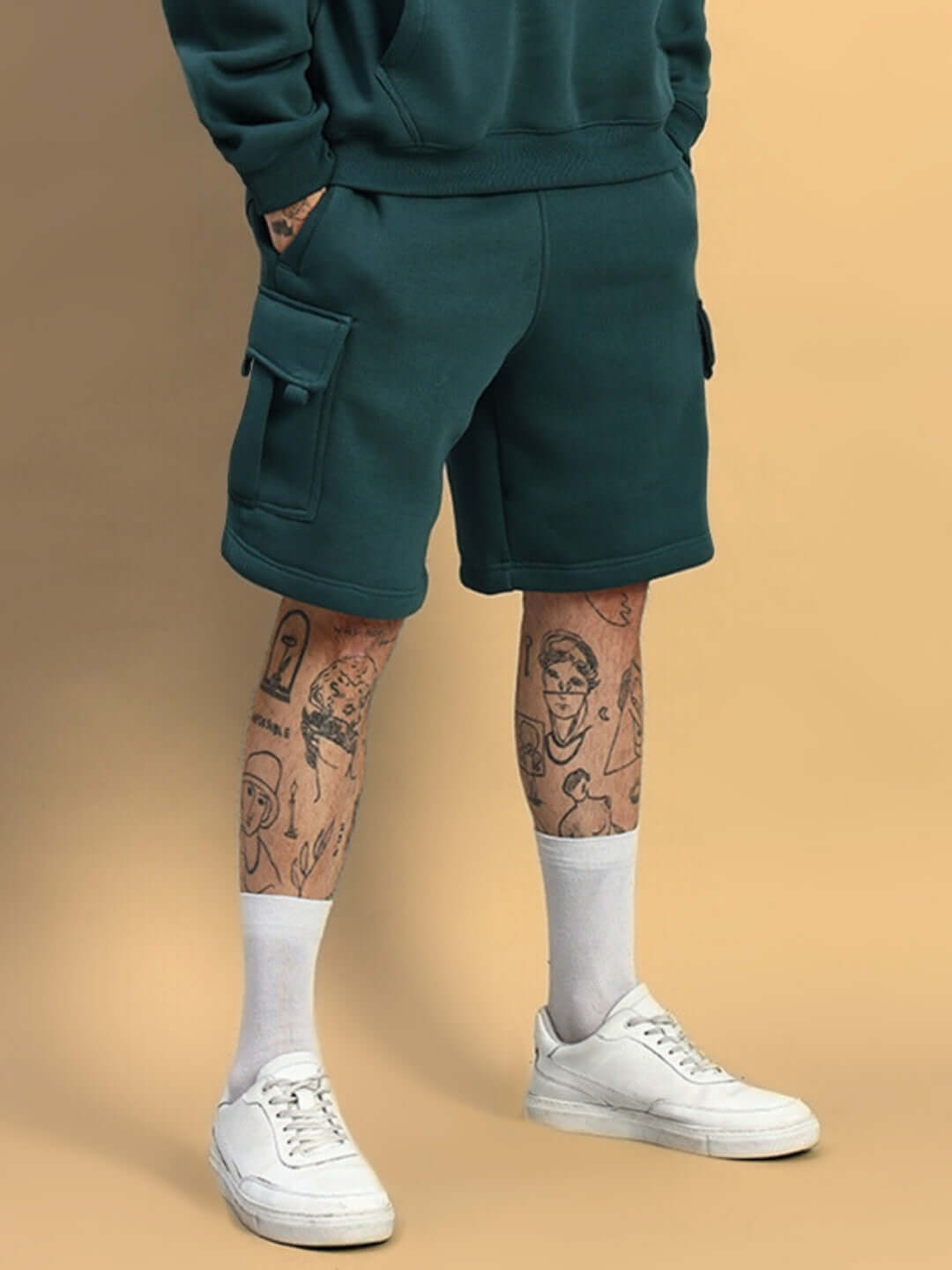 Person wearing HUSKY FLEECE SOLID CARGO SHORTS TEAL GREEN for casual comfort and style.