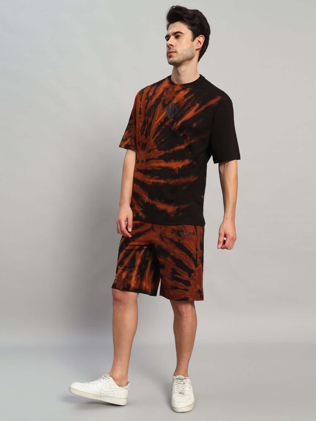 Man modeling HUSTLER TIE-DYE CO-ORD SET BLACK with urban streetwear style, showcasing statement fashion and breathable cotton-blend fabric.