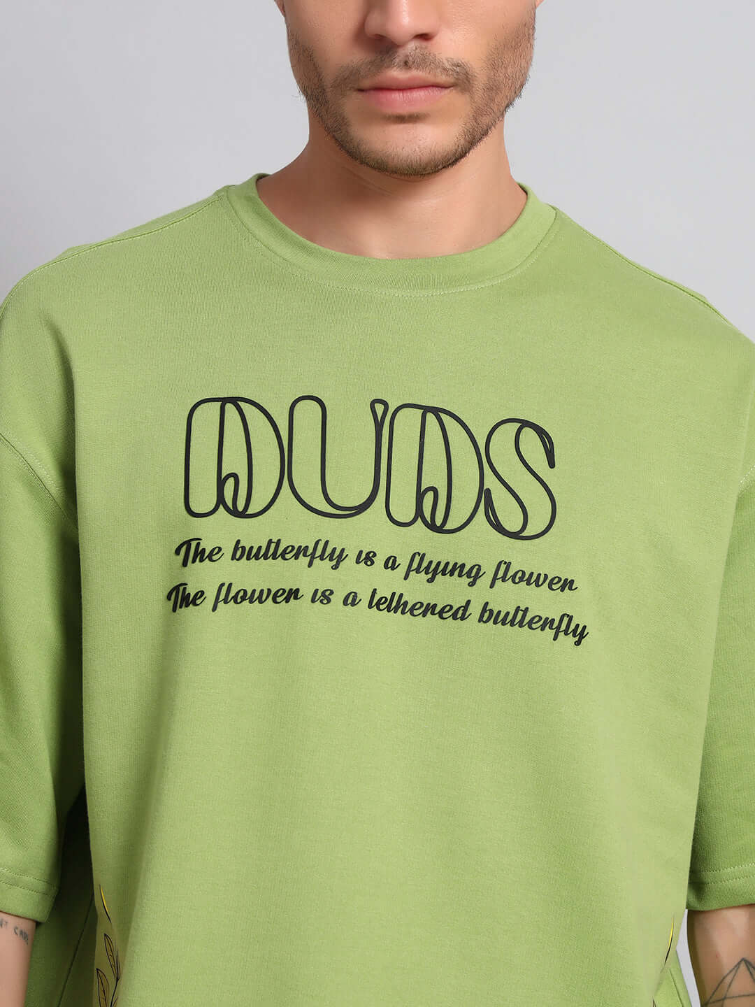 IKON BUTTERFLY T-SHIRT GREEN MEN featuring bold text and butterfly print on vibrant green fabric.