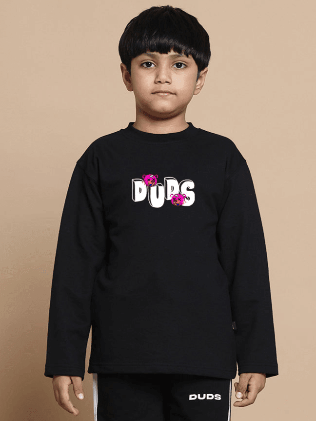 Child wearing I'M OK SWEATSHIRT FOR BOYS GIRLS BLACK with floral print on a beige background.
