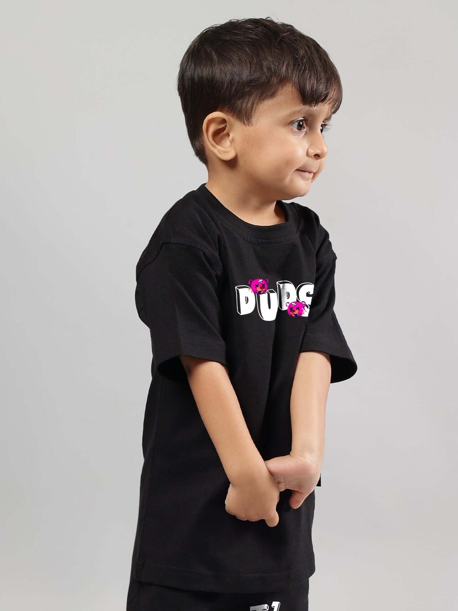 Young child wearing black I'M OK T-shirt for boys and girls by DUDS, custom tailored, available in prepaid orders with custom fit option.