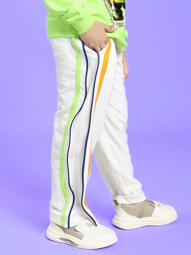 Child wearing IMPERIAL SIDE ZIPPER JOGGER FOR BOYS AND GIRLS OFF WHITE with colorful stripes, perfect for versatile style and comfort.