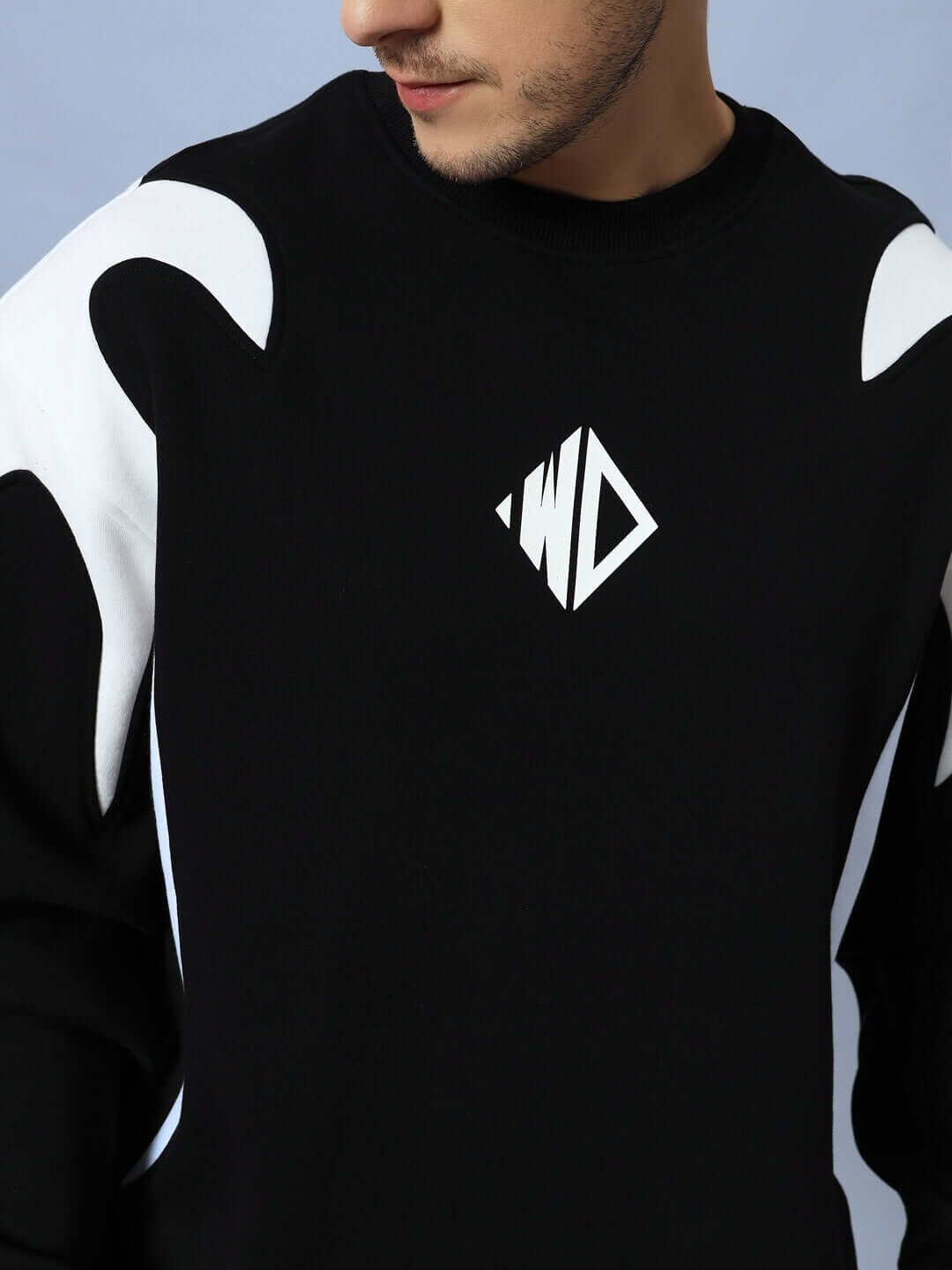 Man wearing INFINITY SAGA OVERSIZED FLEECE SWEATSHIRT BLACK with unique design details.