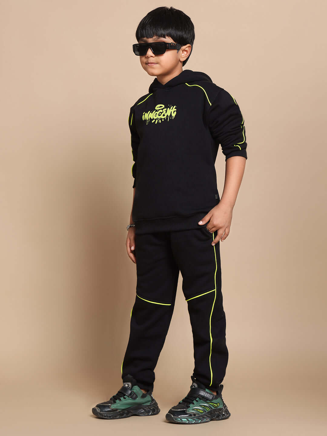 Child wearing Innocent Fleece Co-ord Set in black with neon accents, featuring a sweatshirt and jogger pants for stylish comfort.