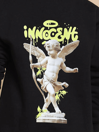 Close-up of Innocent Fleece Co-ord Set featuring a winged cherub design on black fabric.