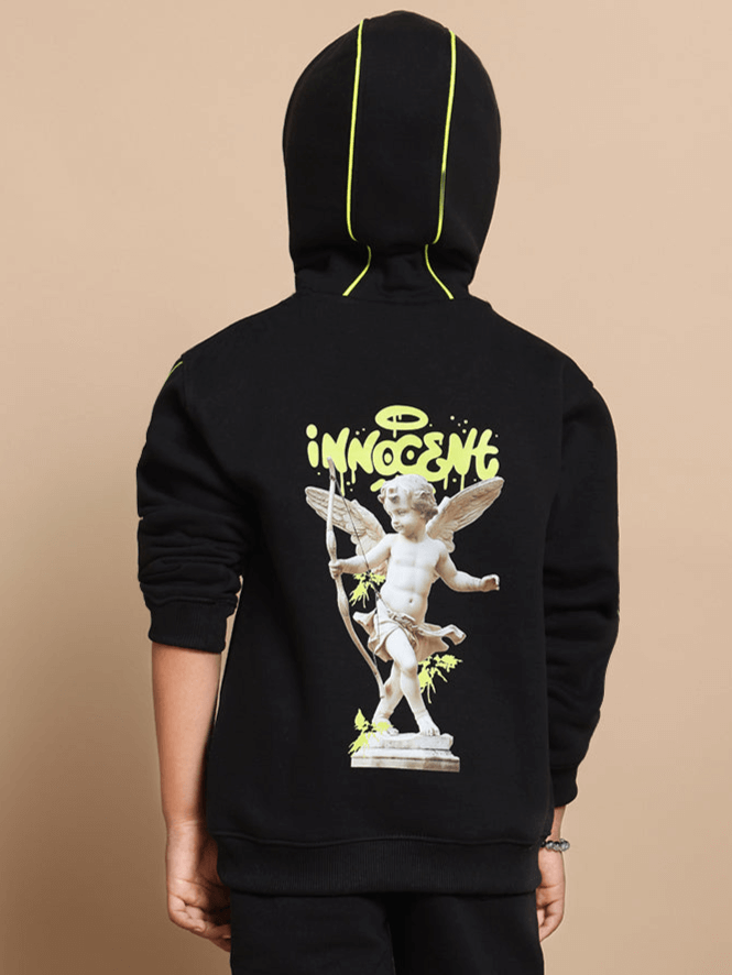 Child wearing Innocent oversized black hoodie with graphic design on the back, suitable for boys and girls.
