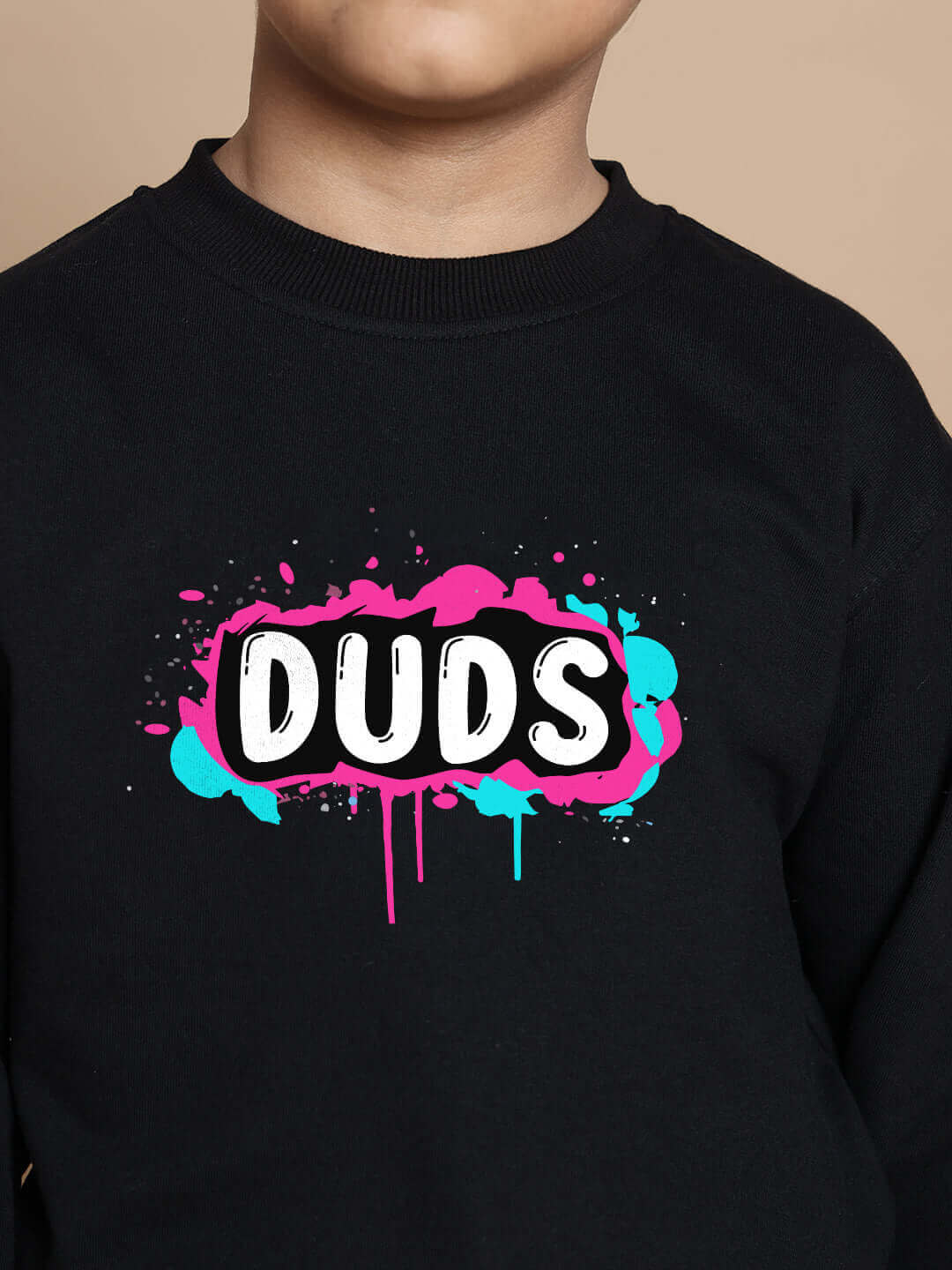 Child wearing black co-ord set with colorful DUDS logo print, designed for boys and girls. Premium cotton blend, relaxed fit.
