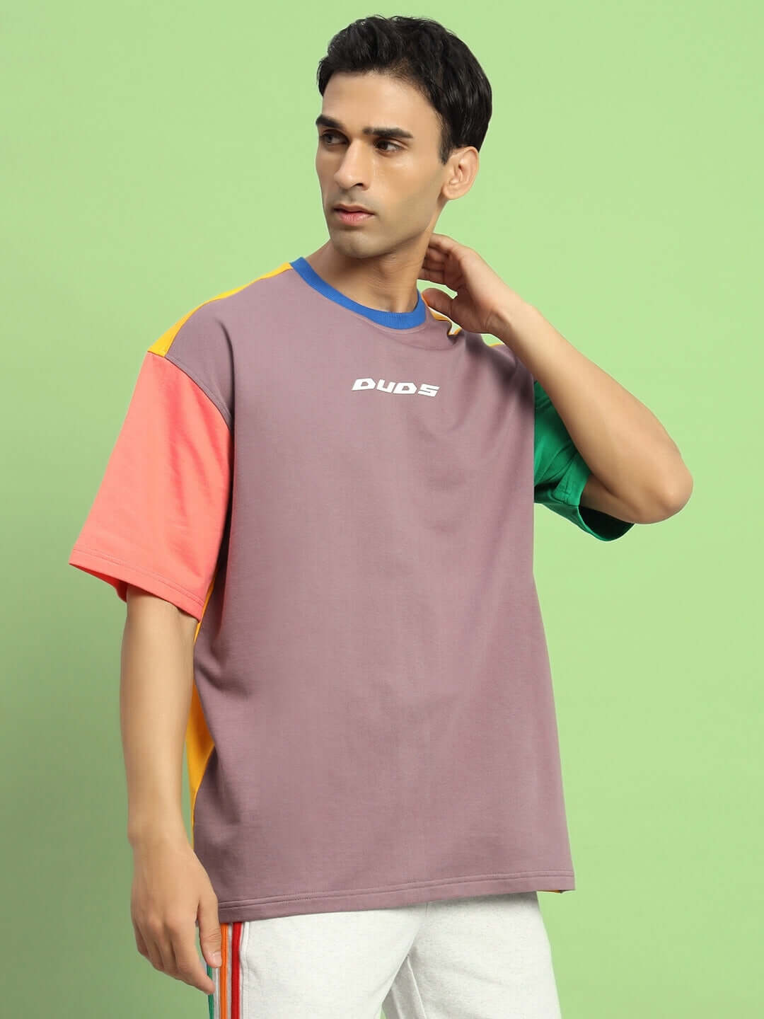 Iris color-blocked oversized t-shirt in multi-color, featuring premium cotton fabric, worn by model against a green background.