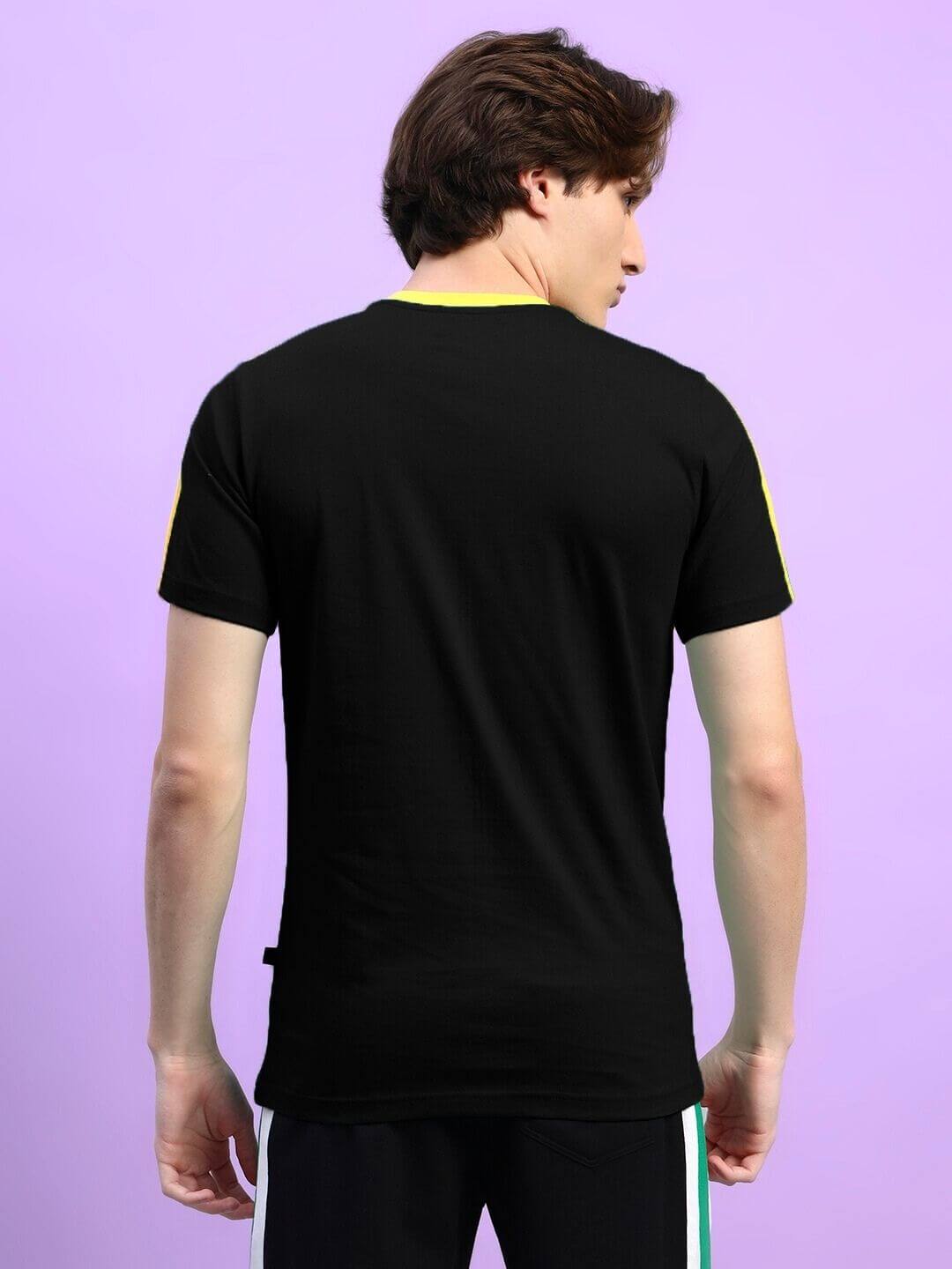 Back view of model wearing IRISH REGULAR FIT T-SHIRT BLACK, showcasing crew neck and short sleeves in premium cotton blend.