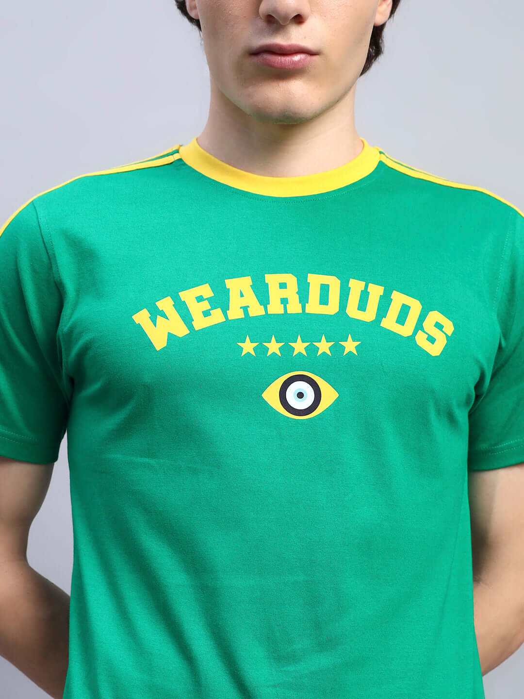Man wearing Irish Regular Fit T-shirt in green with yellow accents and logo, made from premium 100% cotton fabric, 220 GSM.