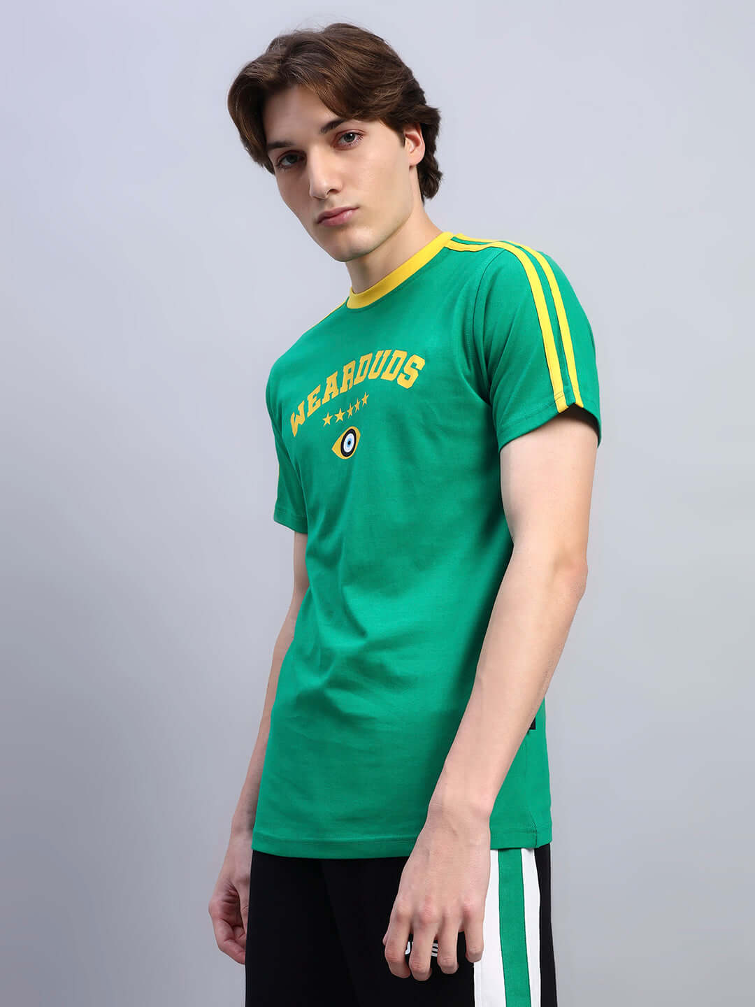 Man wearing a green Irish regular fit t-shirt with yellow stripes and text, made of 100% cotton, 220 GSM bio-washed fabric.