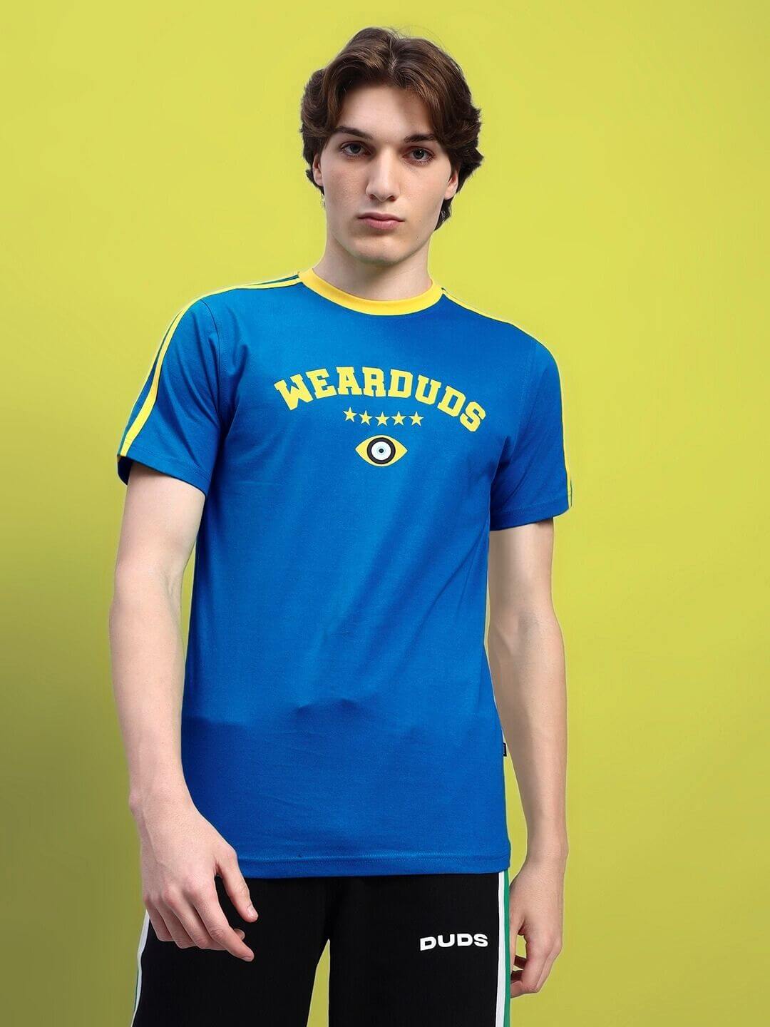 Man wearing blue Irish regular fit t-shirt with yellow accents from Color By Colours, made of 100% bio-washed cotton, origin India.