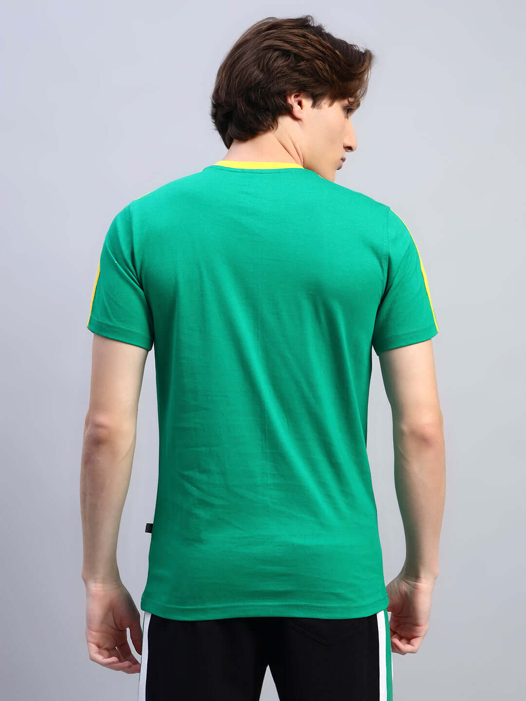 Back view of a person wearing an Irish regular fit green t-shirt made of 100% cotton, highlighting the premium heavy gauge fabric.
