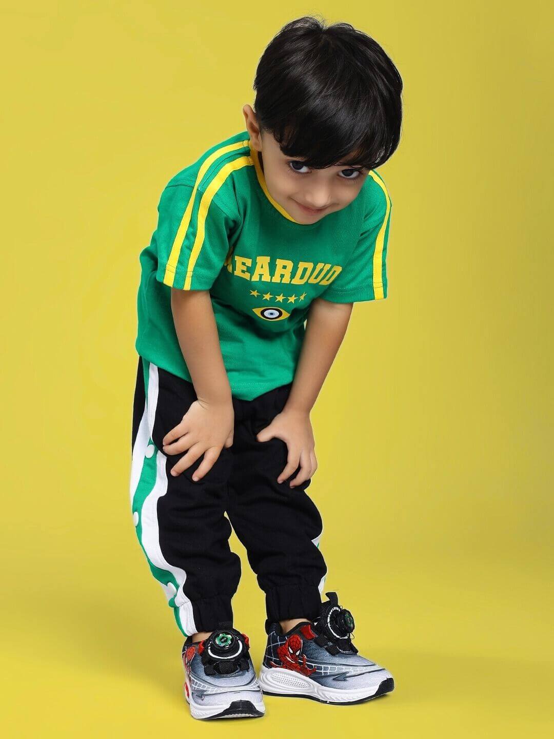 Child wearing IRISH T-SHIRT FOR BOYS AND GIRLS GREEN on yellow background