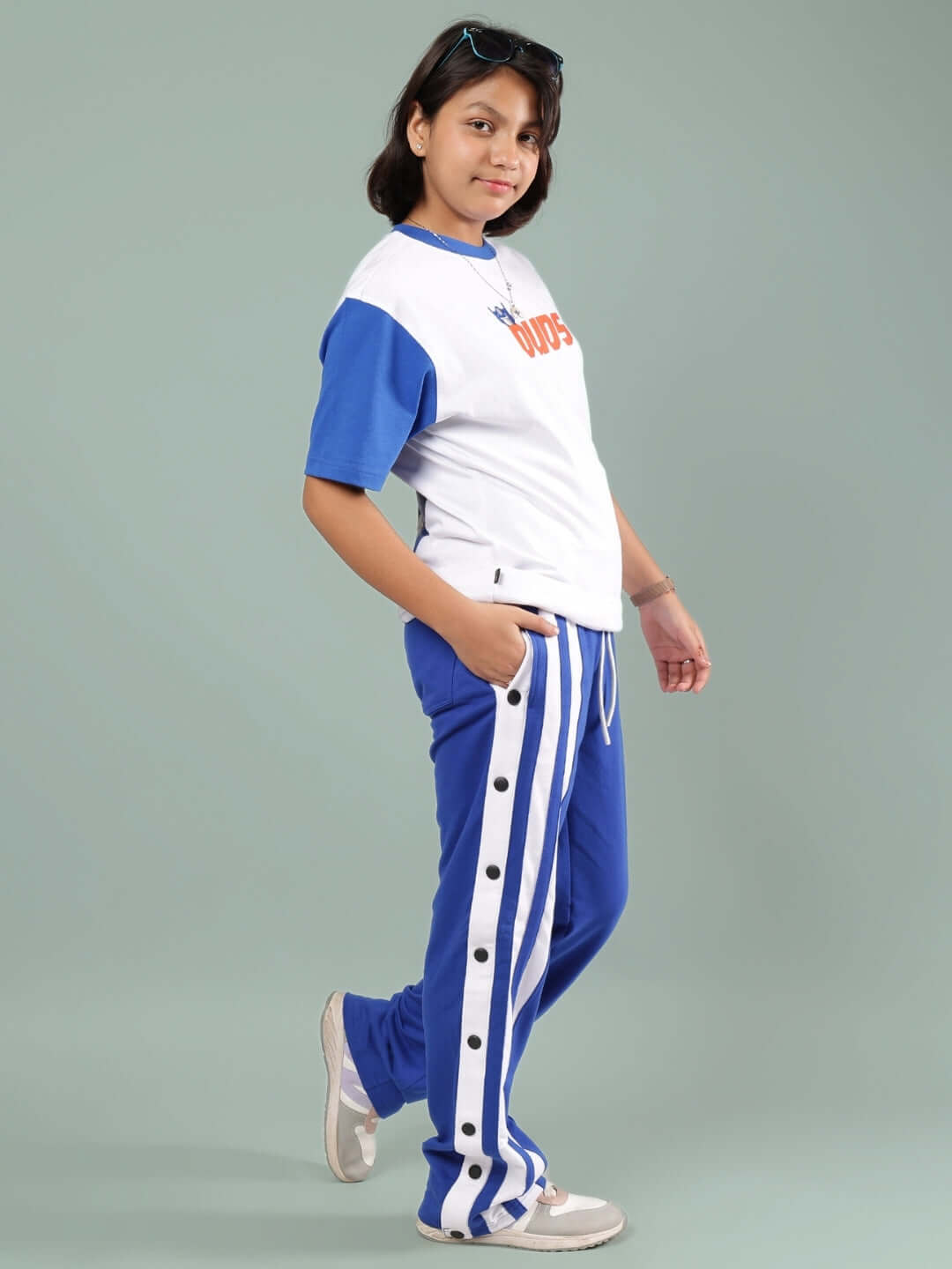 Child wearing IRONA CO-ORD FOR BOYS & GIRLS WHITE-R BLUE, showcasing white and blue outfit by DUDS, perfect for casual and trendy wear.