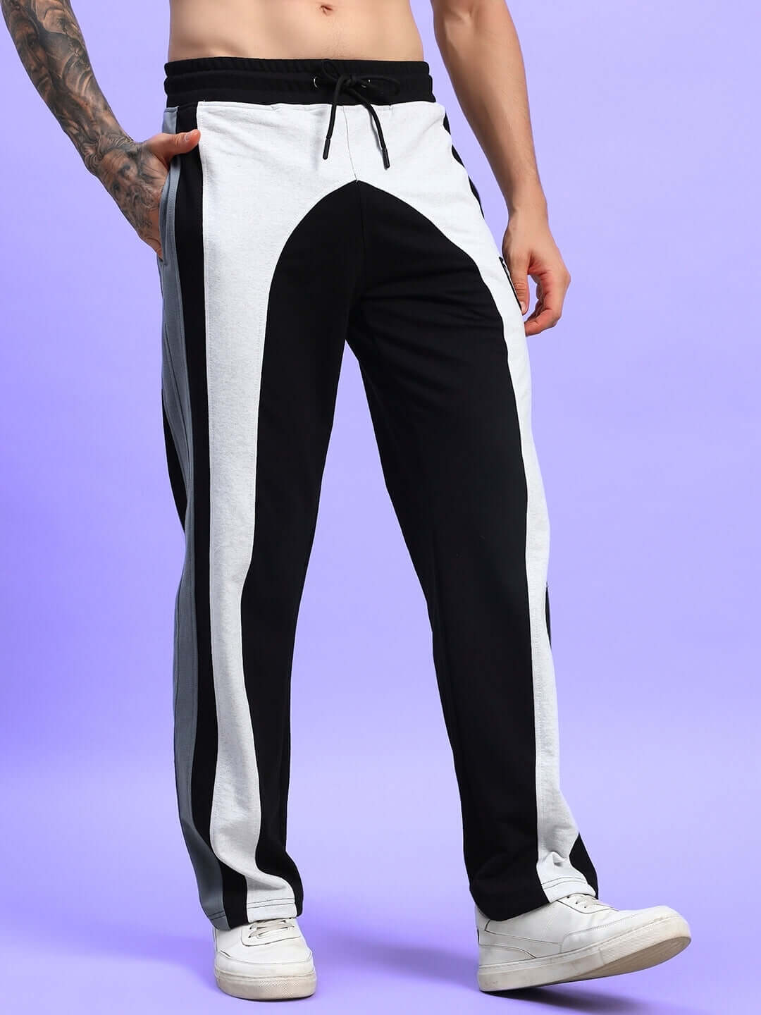 Jamison color block relaxed-fit joggers in black melange-grey with custom fit option, worn by a model, featuring white sneakers.