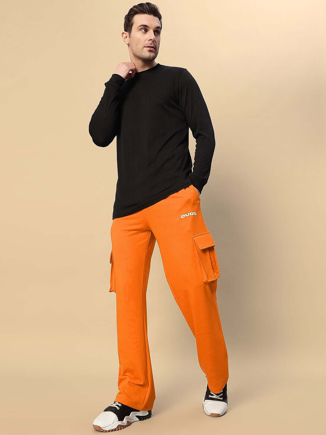Model wearing orange JESS 5 Pocket Relaxed Fit Joggers with black long-sleeve shirt, showcasing casual style and comfort.