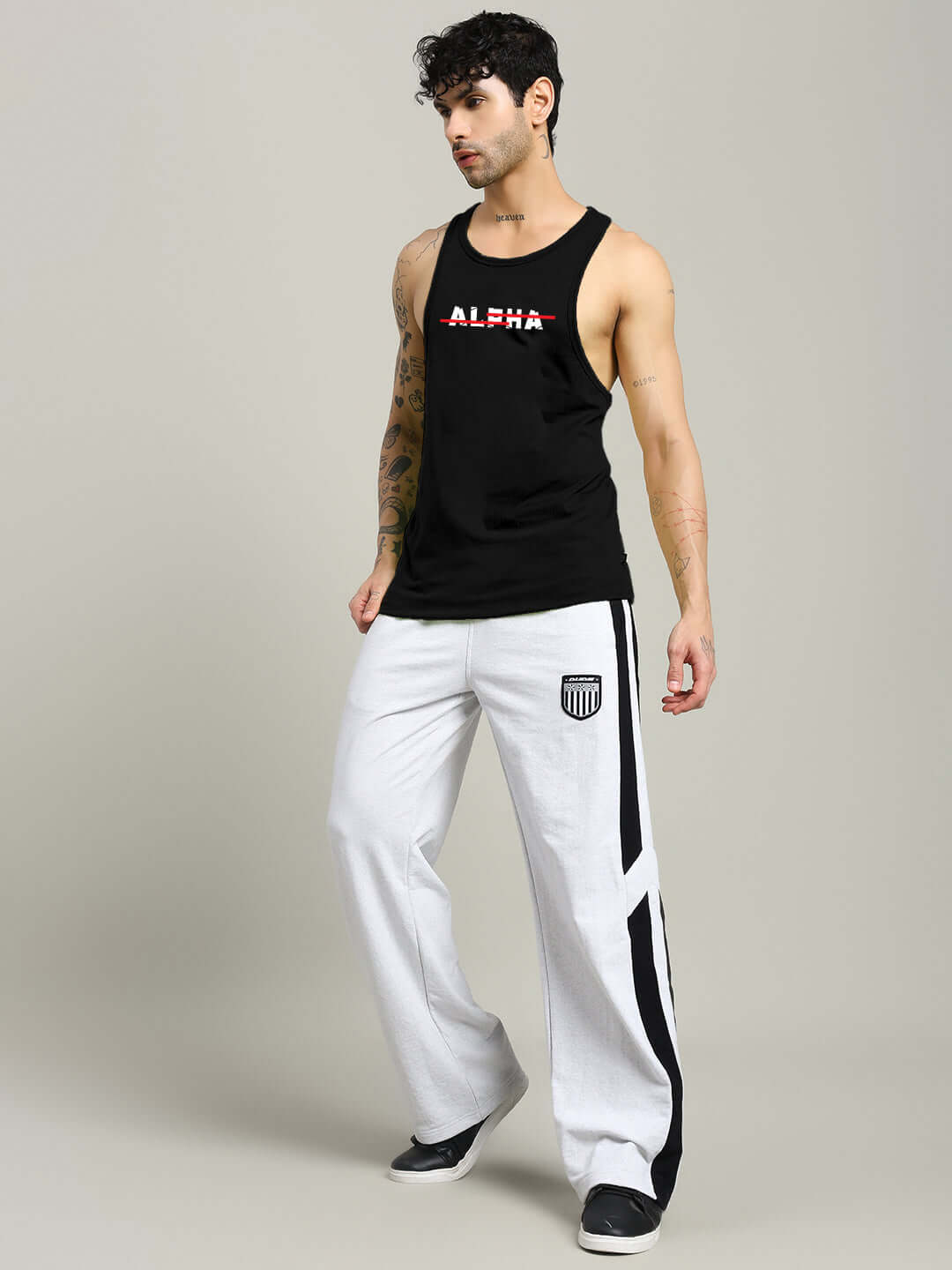 Man wearing JOJO ALPHA PRINTED GYM T-SHIRT BLACK showcasing bold "Alpha" graphic, ideal for gym workouts in sleek black design.