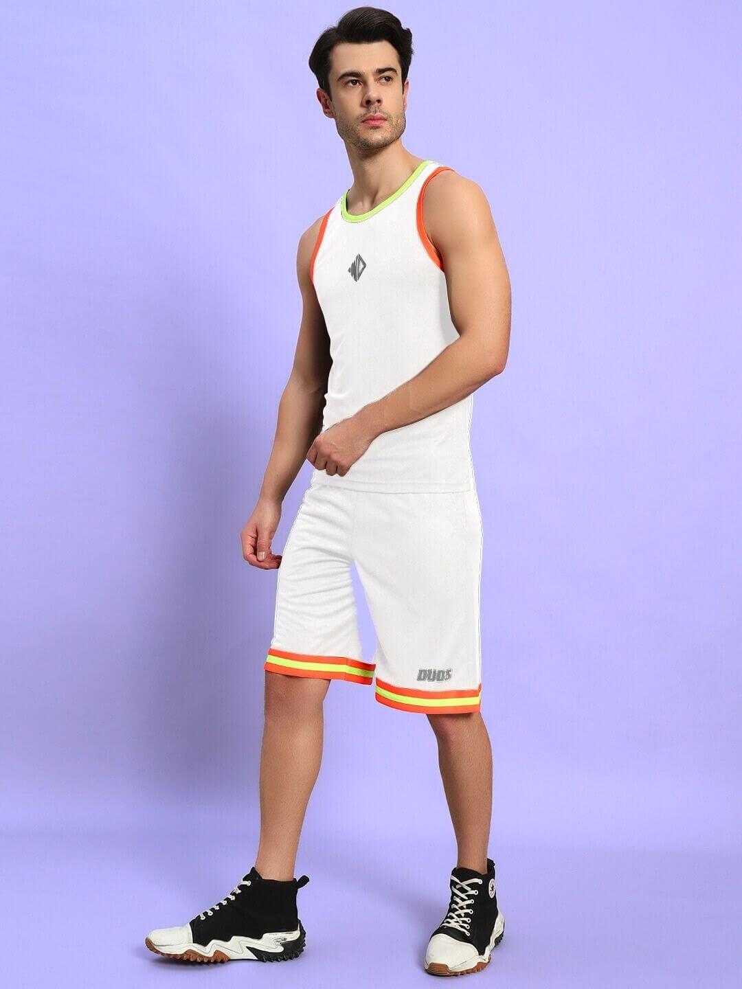 Model wearing JORDAN GYM REGULAR FIT CO-ORD SET WHITE with athletic detailing and sneakers, showcasing sporty elegance against a purple background.