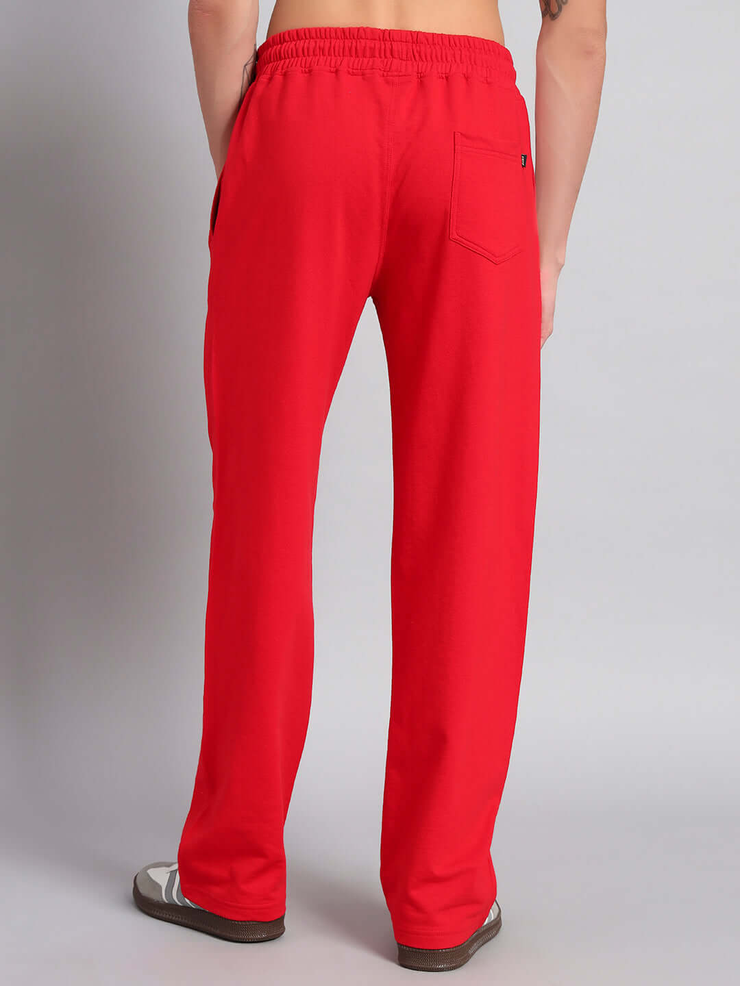 Back view of red JOY FEEL MICKEY relaxed fit joggers made by DUDS, featuring an elastic waistband and single back pocket.