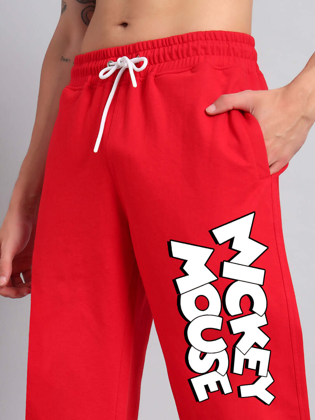 Red Mickey Mouse relaxed fit joggers with white drawstring, available for custom fit and made to order by DUDS.
