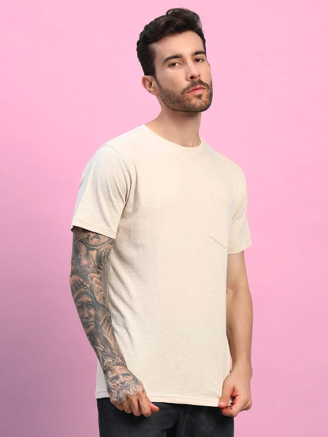 Model wearing JOY Regular Fit T-Shirt in beige, made of 100% premium heavy cotton slub fabric, styled against a pink background.
