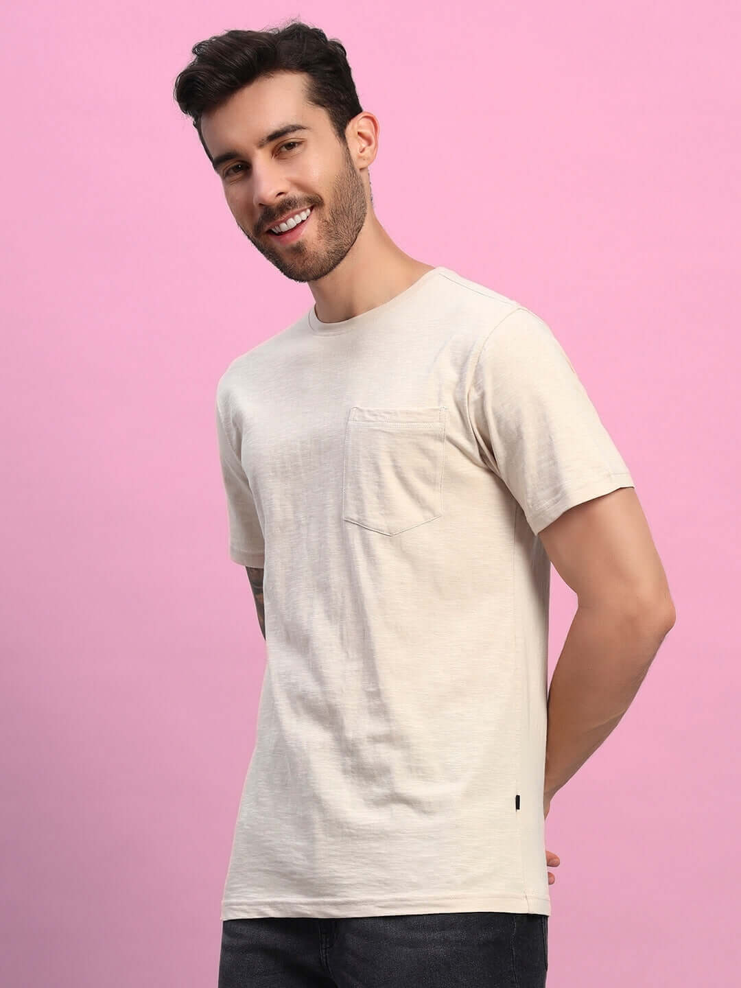 Model wearing JOY regular fit beige t-shirt made of premium heavy cotton slub, ideal for casual wear. 100% bio-washed and India-made.