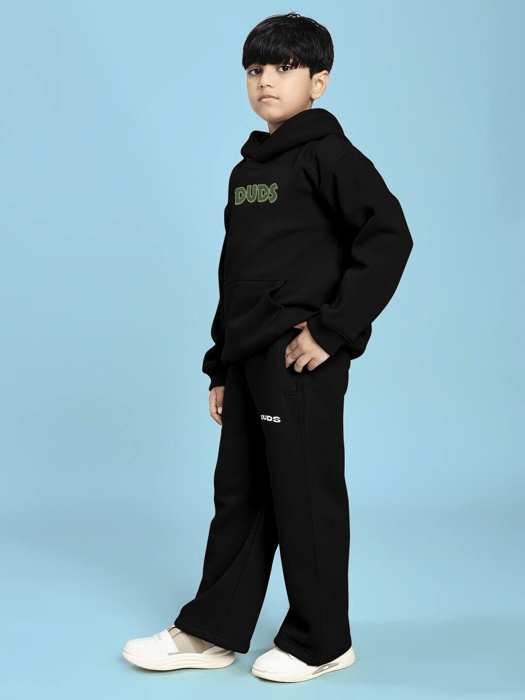 JUDY NICK ZOOTOPIA FLEECE CO-ORD FOR BOYS AND GIRLS BLACK worn by a child standing in a stylish pose against a blue background.