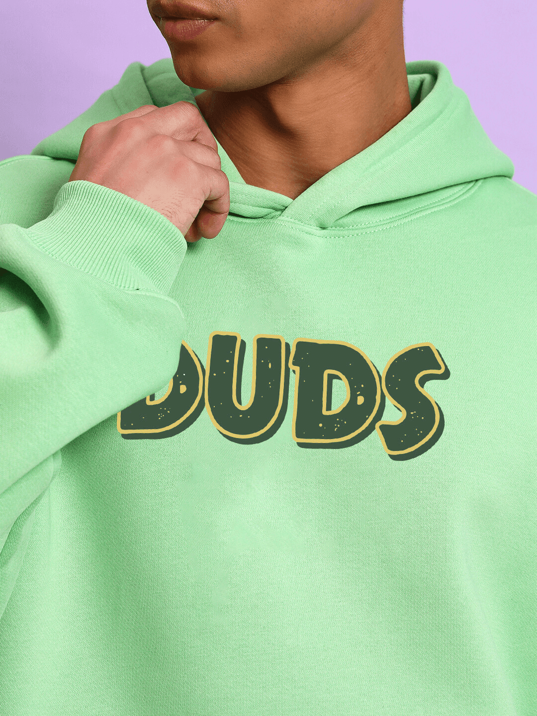 Person wearing JUDY NICK ZOOTOPIA FLEECE HOODIE GREEN with bold lettering.
