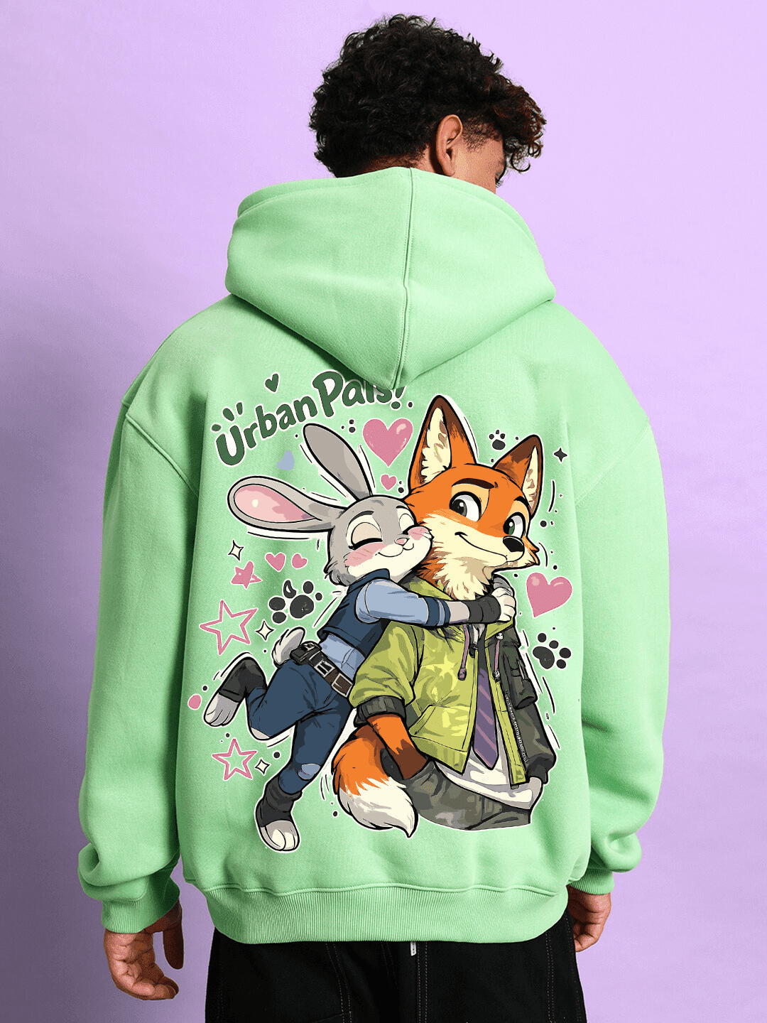 Person wearing JUDY NICK ZOOTOPIA FLEECE HOODIE GREEN featuring Judy and Nick embracing, with playful design on back, perfect for casual wear.