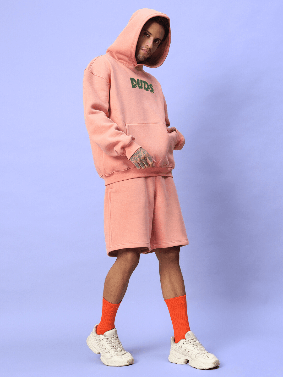 Model wearing JUDY NICK ZOOTOPIA FLEECE CO-ORD PEACH set, showcasing unisex streetwear style in soft peach color with playful characters.